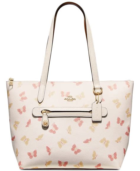 coach handbags with butterflies design.